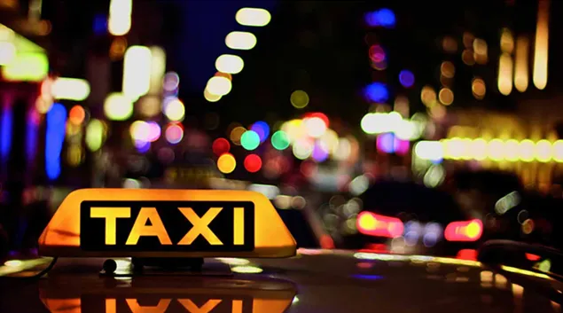 A taxi on a city street A taxi on a city street