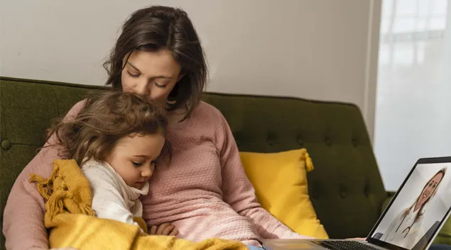 Adult and child on a couch Adult and child on a couch