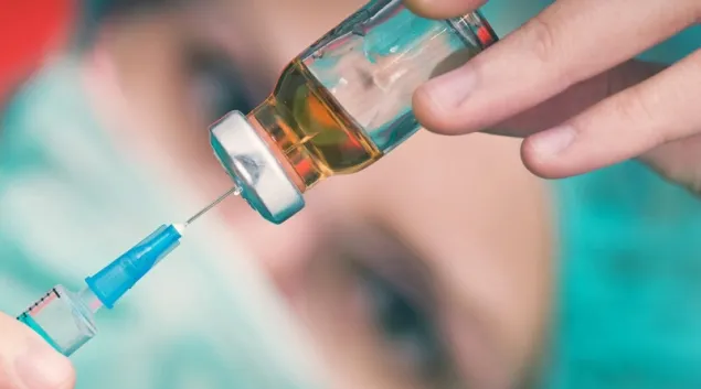 Needle drawing liquid from a vial Needle drawing liquid from a vial
