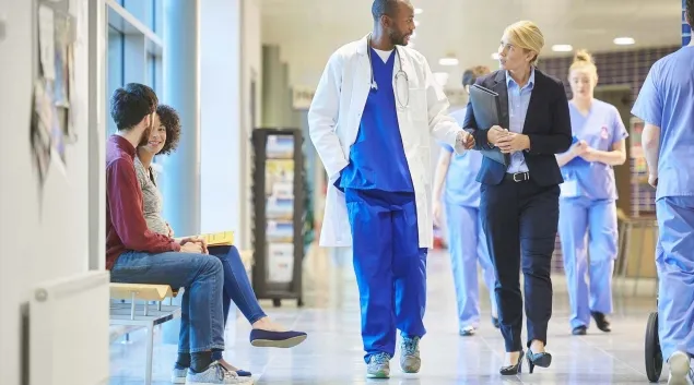 Clinicians walking down hospital corridor