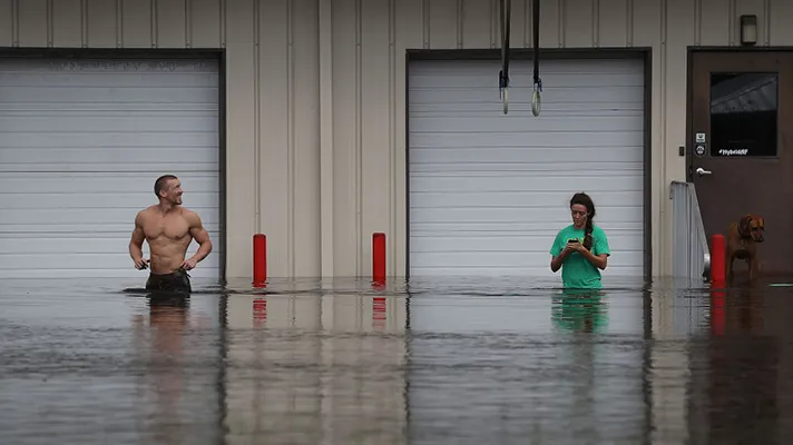 People in a flooded storefront.