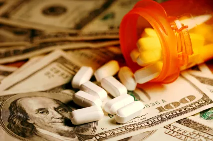 pills spilling onto money