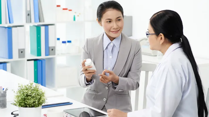 Pharmacy benefit manager talking to pharmacist.