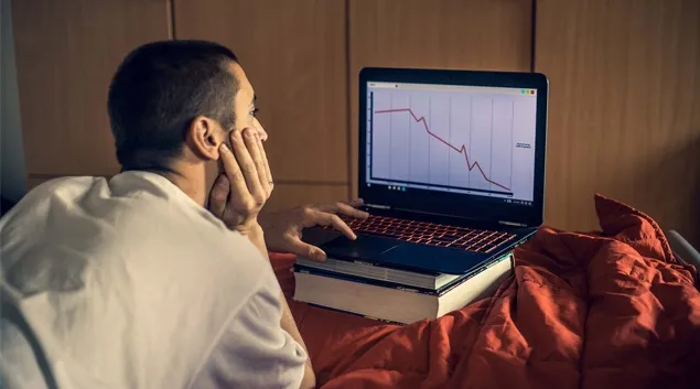 Man looking forlorn while looking at graph