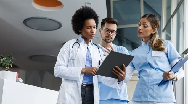 Clinicians huddled around a clipboard