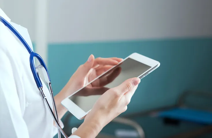 doctor holding tablet