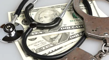 stethoscope and handcuffs on money