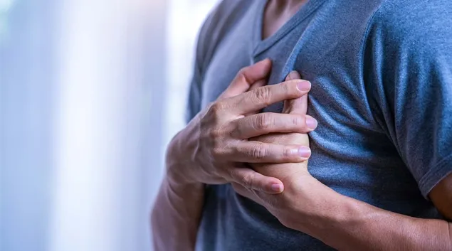 Person clutching their own heart