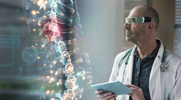 Doctor wearing VR glasses examines 3-D model of spine