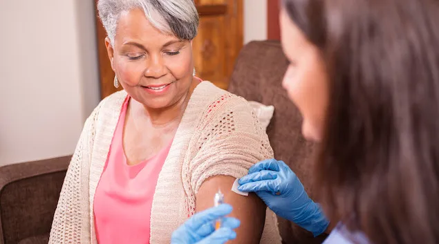 Patient getting a vaccine in their home
