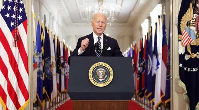 President Biden speaks at podium in White House