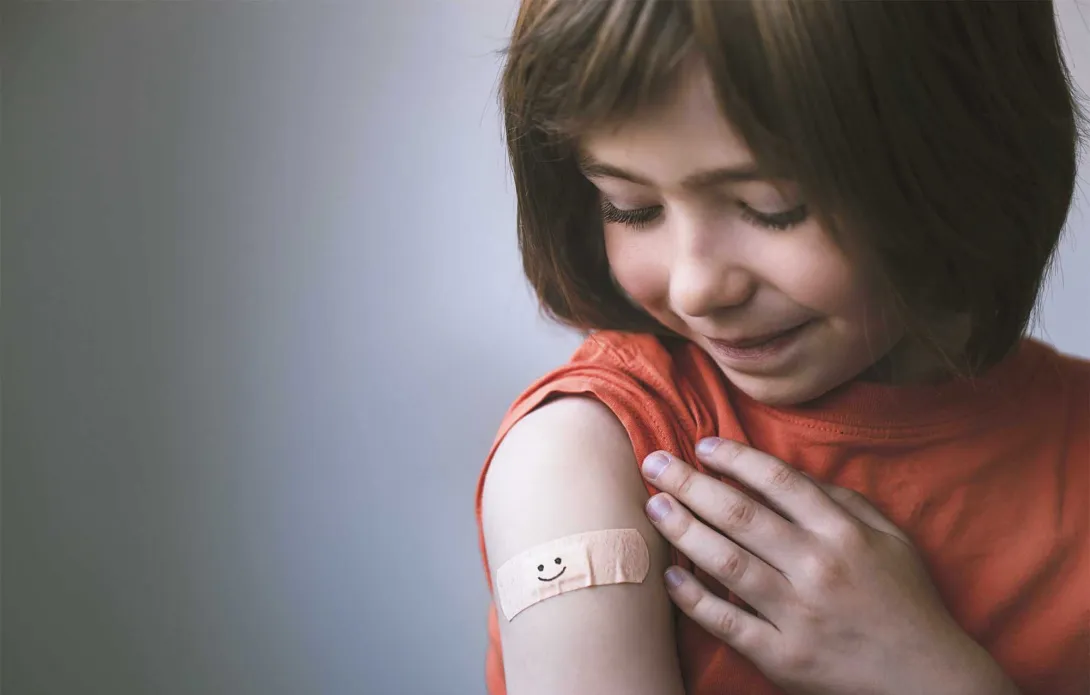 child with bandage after vaccine