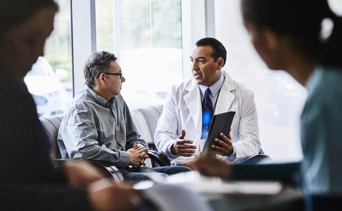 Doctor talks with patient on a couch