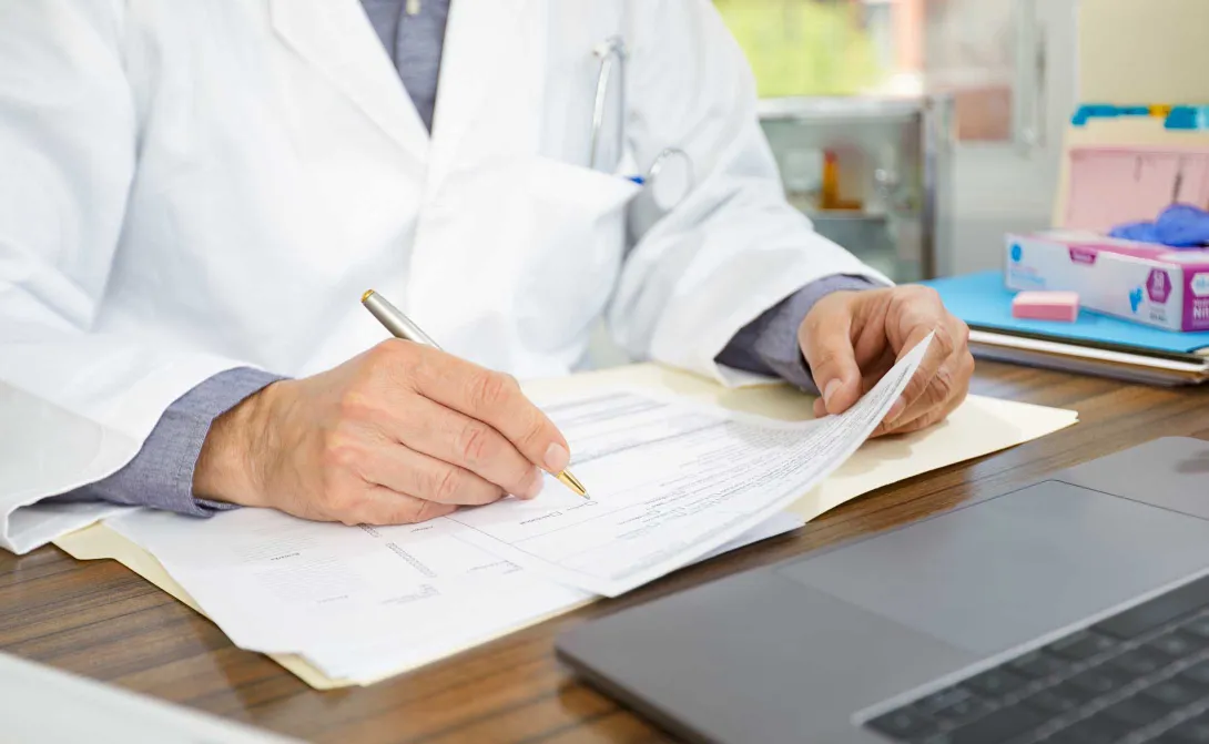 Physician filling out form