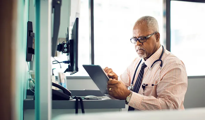 Doctor looking at computer tablet