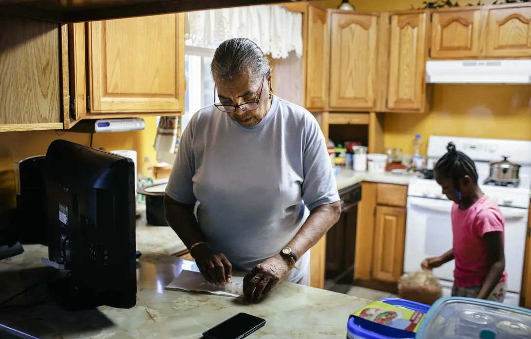 Person reads in kitchen. Photo: Willie B. Thomas/Getty Images