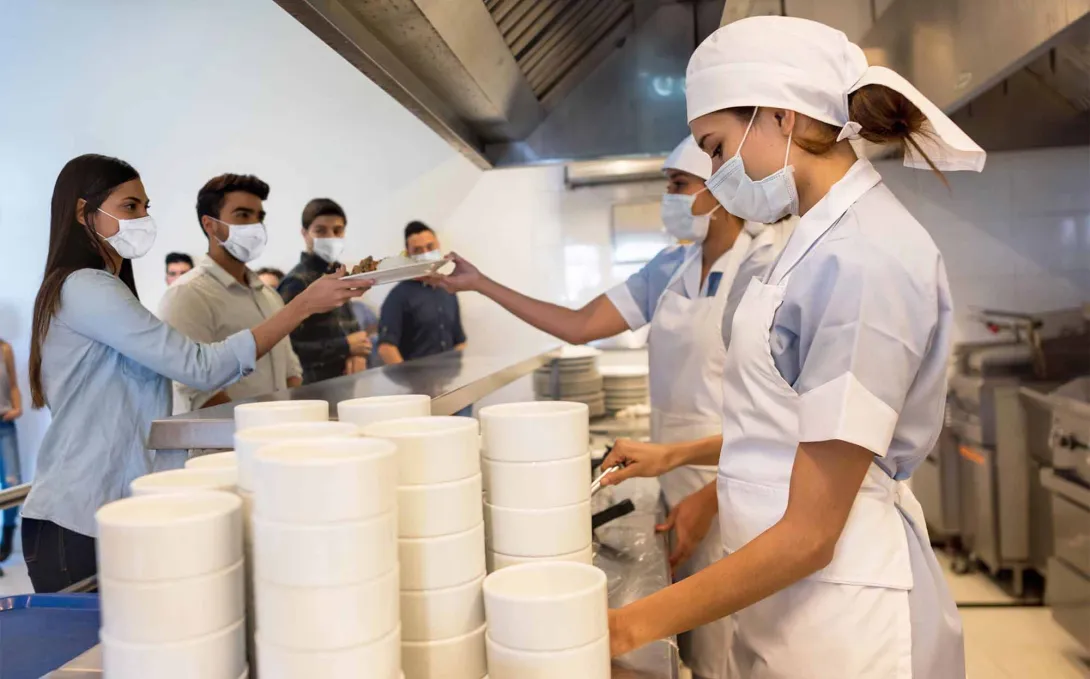 Cafeteria line with food service workers