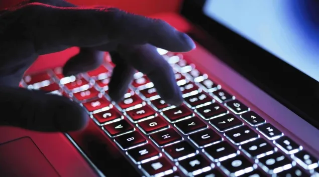 Hand on a glowing keyboard