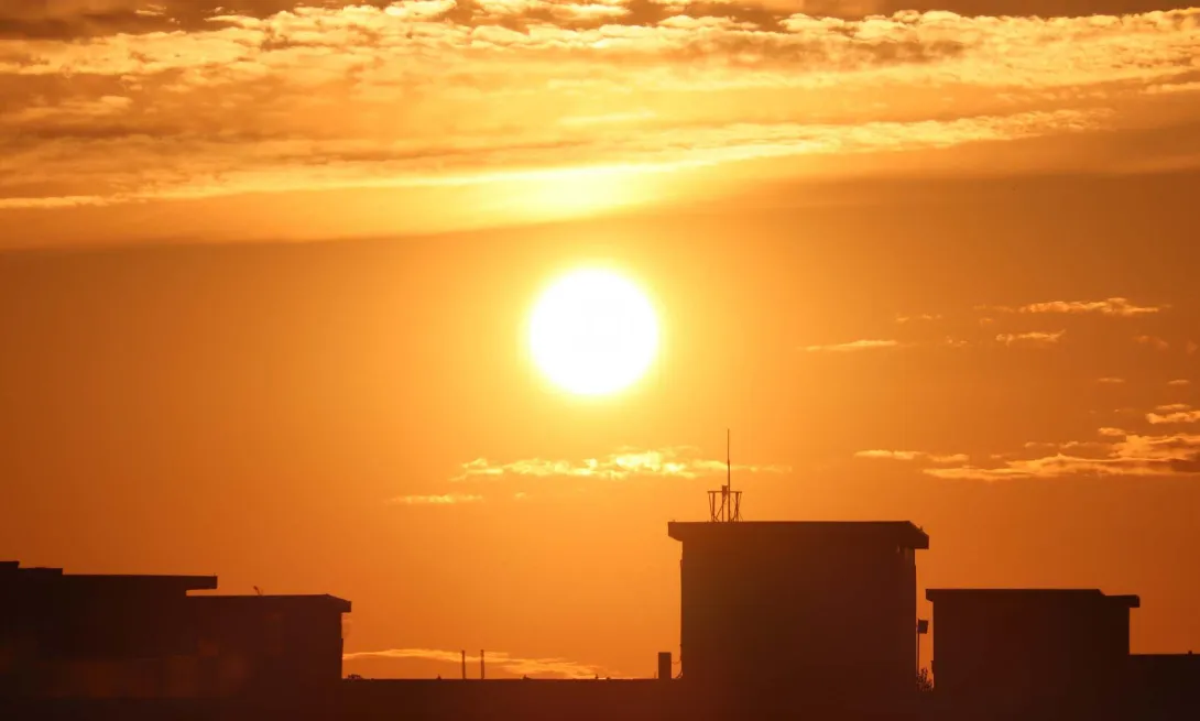 Sun rising over a city