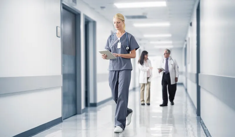 Clinician walking in a hospital hallway