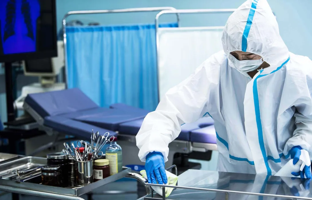 Person in PPE in hospital room