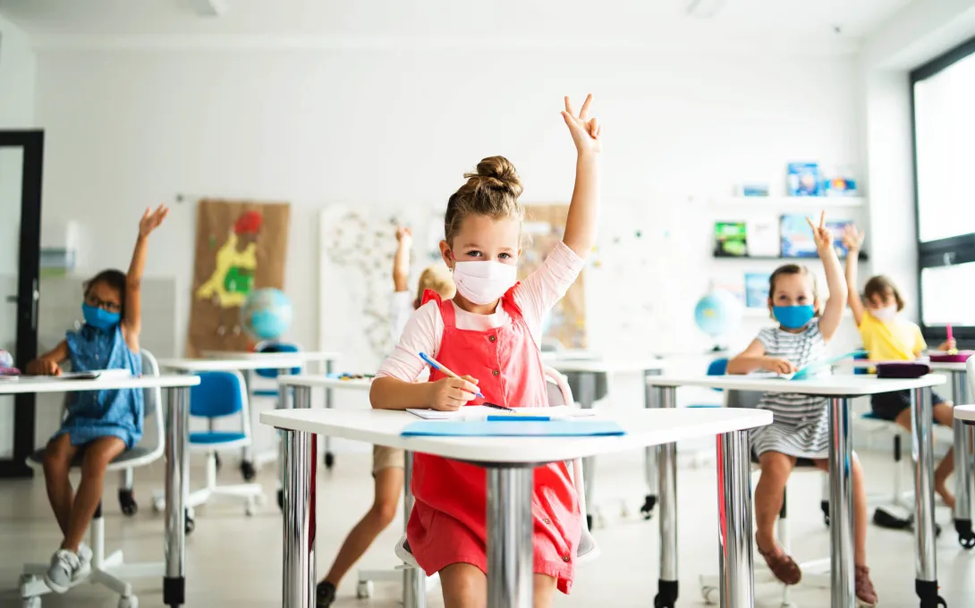 Children masked in a classroom. Photo: Halfpoint Images/Getty Images