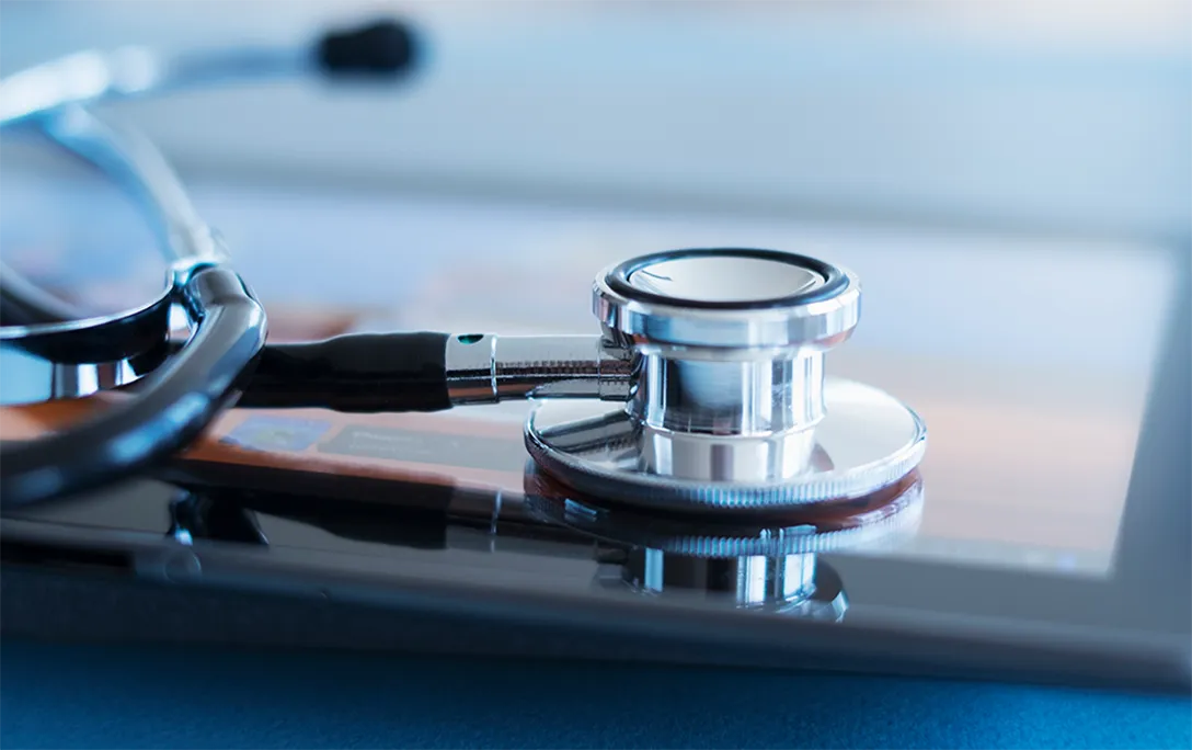 A stethoscope resting on a tablet