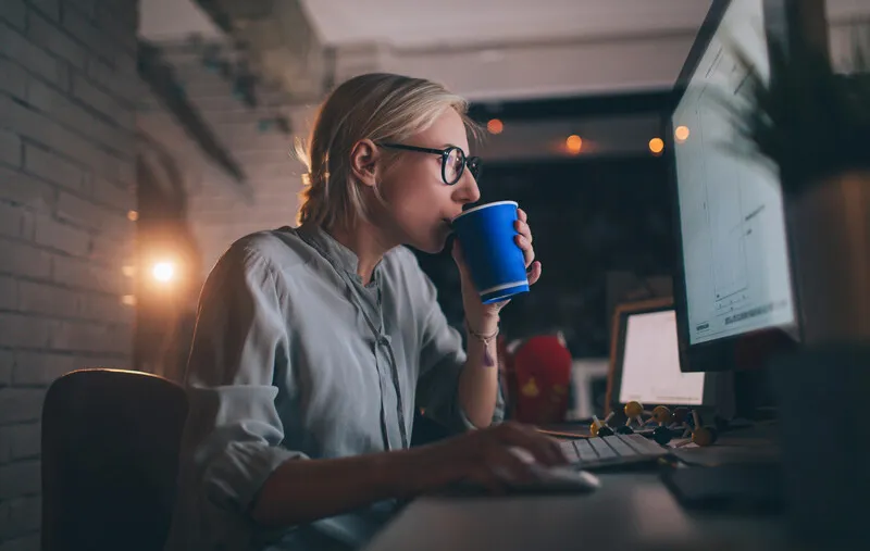 Woman at computer in the dark
