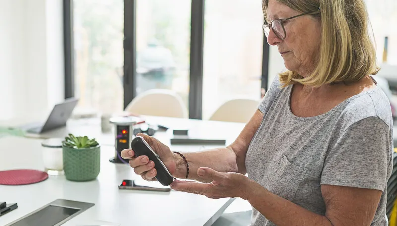 Person with hand-held monitor