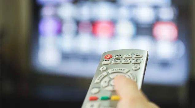 A hand holds a remote