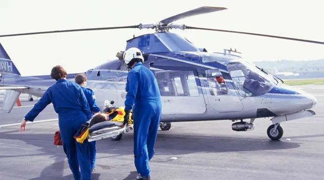 People bringing someone onto an air ambulance