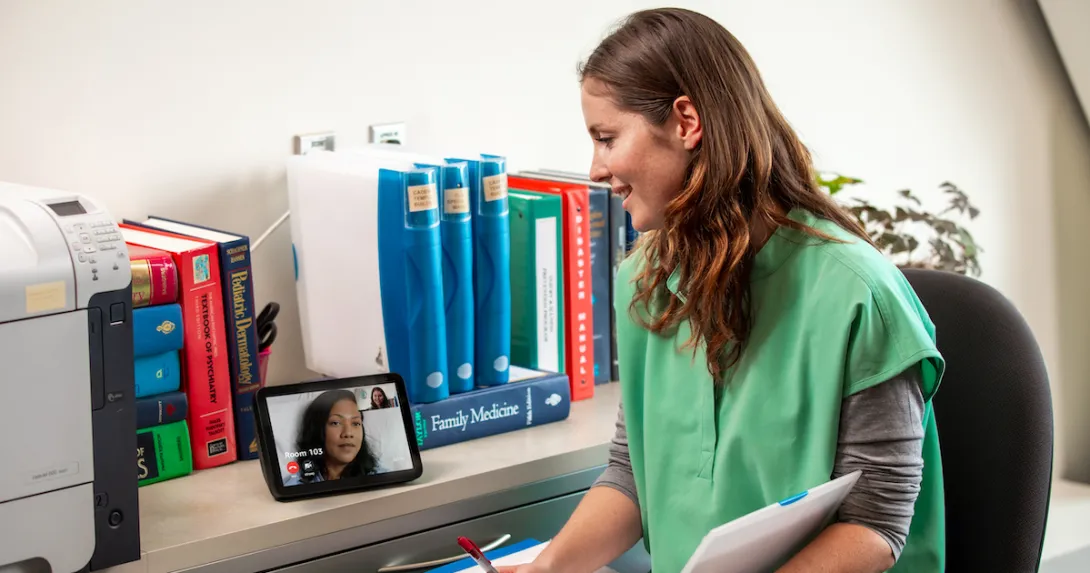 Healthcare worker talking to patient on tablet