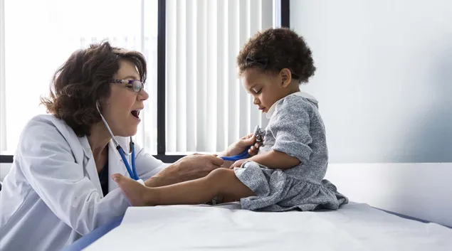 Doctor examining toddler