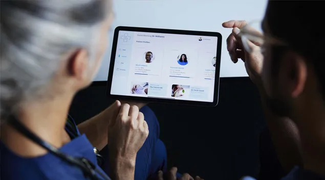 Doctor and patient examine tablet