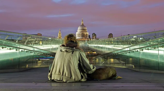 Homeless person with U.S. Capitol in the distance