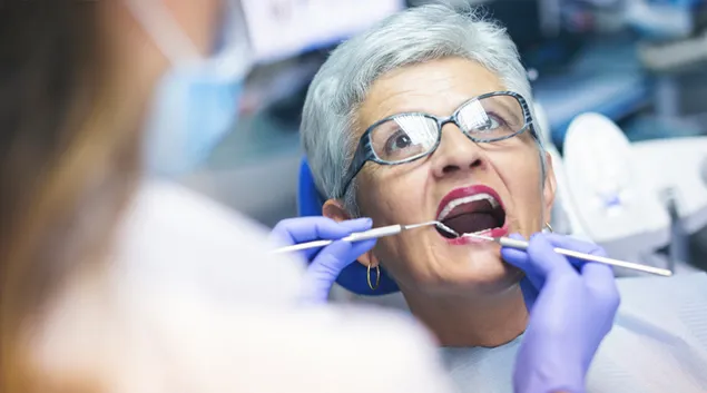 Dentist treating older patient