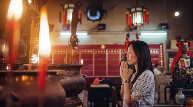 Person praying in religious setting